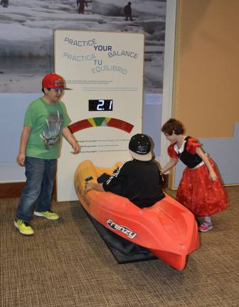 Fifth-grade students from New York City Public School 276 try out a kayak balancing activity at the imagiNATIONS Activity Center grand opening ceremony on Thursday, May 17, 2018. Photo: Jason DeCrow/AP Images for Smithsonian's National Museum of the American Indian&#xa0;