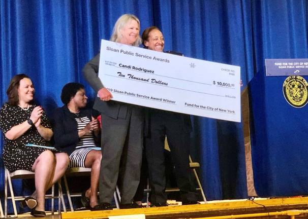 School safety officer Candi Rodriguez, right, receives a check for $10,000 from Paula Olsiewski, program director, Alfred P. Sloan Foundation. Photo: Emily Higginbotham